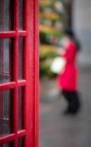 Lady in red coat and white handbag - Tony Bramley